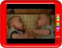 Twin baby boys laughing at each other